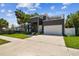 Contemporary two-story home with a spacious driveway and a rooftop deck, perfect for outdoor entertainment at 4406 W Euclid Ave, Tampa, FL 33629