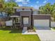 Stunning two-story home featuring a modern design with a balcony and a well-manicured lawn at 4406 W Euclid Ave, Tampa, FL 33629