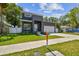 Contemporary two-story home with a well-manicured lawn and modern design elements at 4406 W Euclid Ave, Tampa, FL 33629