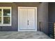 A close-up view of the double front doors with a gray exterior, and the gray tiling at 4406 W Euclid Ave, Tampa, FL 33629
