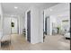 Bright hallway with natural light showcasing wood floors, modern doors, and a peek into bedroom at 4406 W Euclid Ave, Tampa, FL 33629