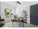 Bright home office with a dark wooden desk, dark door, a ceiling fan and large window at 4406 W Euclid Ave, Tampa, FL 33629