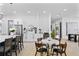 Open-concept kitchen featuring stainless steel appliances and a marble breakfast table at 4406 W Euclid Ave, Tampa, FL 33629