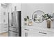 A modern kitchen counter featuring white cabinetry, stainless steel appliances, and decorative elements at 4406 W Euclid Ave, Tampa, FL 33629