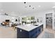 Open concept kitchen with a navy island, quartz countertops, and modern pendant lighting at 4406 W Euclid Ave, Tampa, FL 33629