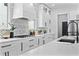 Well-lit kitchen with white cabinets, quartz countertops, and stainless steel appliances at 4406 W Euclid Ave, Tampa, FL 33629