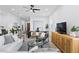 Open-concept living space features a white couch, light wood floors, and abundant natural light at 4406 W Euclid Ave, Tampa, FL 33629