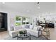 Open living space with a white sofa and sliding doors leading to an outdoor space at 4406 W Euclid Ave, Tampa, FL 33629