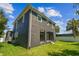 Back exterior of a modern home featuring a balcony, a patio, and a well-maintained lawn at 4406 W Euclid Ave, Tampa, FL 33629