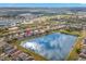 Aerial view of community homes surrounding lake with the red arrow pointing to the subject property at 5236 Clover Mist Dr, Apollo Beach, FL 33572