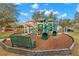 Community playground with slides, climbing structures, and green bench at 5236 Clover Mist Dr, Apollo Beach, FL 33572