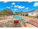 Community pool area featuring lounge chairs, covered seating, and a nearby playground at 5236 Clover Mist Dr, Apollo Beach, FL 33572