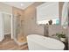 Bright bathroom features a soaking tub next to a standalone shower with decorative tile at 7718 Landcare Ln, Tampa, FL 33616