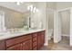 Bathroom featuring double sinks, wood look tile, and walk-in shower at 7718 Landcare Ln, Tampa, FL 33616