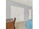Cozy bedroom featuring double closets, a wood desk, and natural light at 7718 Landcare Ln, Tampa, FL 33616