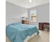 Comfortable bedroom with neutral colors, a ceiling fan, and lots of natural light at 7718 Landcare Ln, Tampa, FL 33616