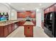 Spacious kitchen with granite countertops, stainless steel appliances, and a central island at 7718 Landcare Ln, Tampa, FL 33616