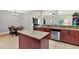 Kitchen featuring granite countertops, stainless steel appliances, island, and breakfast nook at 7718 Landcare Ln, Tampa, FL 33616
