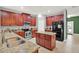 Well-equipped kitchen with granite countertops, stainless steel appliances, and an island at 7718 Landcare Ln, Tampa, FL 33616