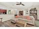 Inviting living room with comfortable seating, ceiling fan, and seamless access to dining area at 7718 Landcare Ln, Tampa, FL 33616