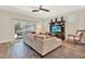 Open-concept living room featuring modern furniture, ceiling fan, and sliding glass door to patio at 7718 Landcare Ln, Tampa, FL 33616