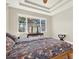 Bright primary bedroom with window and wood-look flooring at 7718 Landcare Ln, Tampa, FL 33616