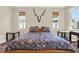 Bright primary bedroom with windows and wood-look flooring at 7718 Landcare Ln, Tampa, FL 33616