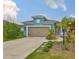 Charming single-Gathering home with a two-car garage, neat landscaping, and a light blue exterior at 11008 Sand Pine Ln, Parrish, FL 34219