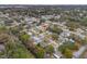 Aerial view of a residential neighborhood with tree-lined streets, nearby creek, and convenient access to local amenities at 1230 7Th Ne Ave, Largo, FL 33770