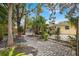 Expansive backyard featuring stone pathways, lush landscaping, and a tranquil patio area perfect for outdoor entertaining and relaxation at 1230 7Th Ne Ave, Largo, FL 33770