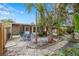 Serene backyard patio with lush landscaping, complete with a table and chairs for outdoor dining and relaxation in a tropical oasis at 1230 7Th Ne Ave, Largo, FL 33770