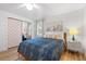 Cozy bedroom with a queen bed, mirrored closet, ceiling fan, and a city scene art piece at 1230 7Th Ne Ave, Largo, FL 33770