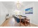 Open-concept dining area with a chandelier, leading into the living room; hardwood flooring throughout at 1230 7Th Ne Ave, Largo, FL 33770