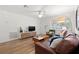 Comfortable living room featuring modern decor, hardwood floors, and bright light from the windows at 1230 7Th Ne Ave, Largo, FL 33770