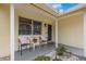 Cozy front porch with seating, decorative plants, and a welcoming entrance to the home at 1230 7Th Ne Ave, Largo, FL 33770