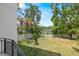 Spacious backyard overlooking a tranquil lake, perfect for outdoor enjoyment and relaxation at 1802 E Park Cir, Tampa, FL 33610