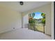 Open-air balcony with tiled floor, black metal railing and a view of the backyard and a lake at 1802 E Park Cir, Tampa, FL 33610