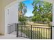 Balcony view showcasing lush greenery and a serene lake, offering a peaceful retreat at 1802 E Park Cir, Tampa, FL 33610