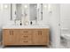 Bathroom with double sink vanity, marble countertop, and custom wood cabinetry at 1802 E Park Cir, Tampa, FL 33610