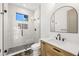 Modern bathroom featuring a glass-enclosed shower, stylish vanity, and unique tile work at 1802 E Park Cir, Tampa, FL 33610