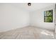 Bright bedroom featuring modern herringbone flooring and a large window with natural light at 1802 E Park Cir, Tampa, FL 33610