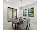 Bright dining area with modern lighting, sleek table, and views of the outdoors at 1802 E Park Cir, Tampa, FL 33610