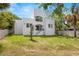 Modern home exterior surrounded by green lawns and mature trees, creating a welcoming ambiance at 1802 E Park Cir, Tampa, FL 33610