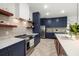 Open kitchen with stainless appliances, herringbone floors, and ample cabinet space at 1802 E Park Cir, Tampa, FL 33610
