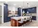 Bright kitchen featuring navy cabinets, herringbone floors, and island seating at 1802 E Park Cir, Tampa, FL 33610