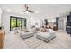 Bright, open-concept living room featuring a modern sectional, stylish decor, and beautiful herringbone floors at 1802 E Park Cir, Tampa, FL 33610