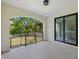 Open patio with an arched entrance, tile floor, black railing, and sliding glass doors at 1802 E Park Cir, Tampa, FL 33610