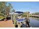 Docked pontoon boat offers waterfront living and boating convenience, set against a picturesque canal at 18350 Burkholder Cir, Port Charlotte, FL 33948