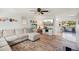 Inviting living room featuring wood floors, modern decor, and seamless transition to the kitchen at 18350 Burkholder Cir, Port Charlotte, FL 33948