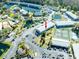 Aerial view of condo complex surrounded by ponds, palm trees, tennis courts, and parking at 1849 Abrico Dr # 4, Lutz, FL 33558